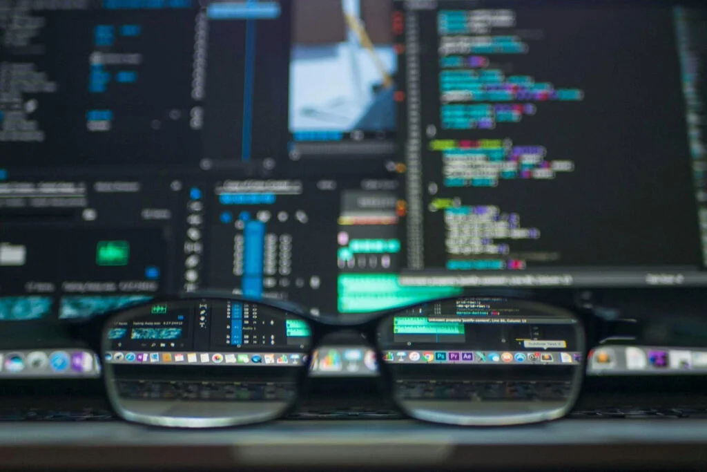 Close-up of computer screen with code and software tools, viewed through glasses—symbolizing focus on free PC utilities and developer tools.